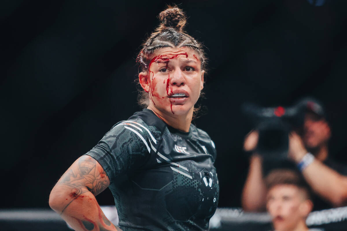 Mayra Bueno Silva is bloodied by Macy Chiasson during the bantamweight bout at UFC 303 at T-Mob ...