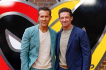 Ryan Reynolds, left, and Hugh Jackman pose for photographers upon arrival at the screening of t ...