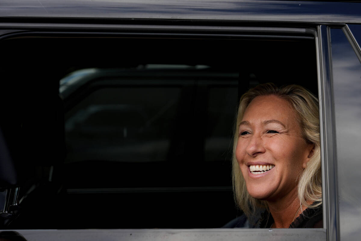 Rep. Marjorie Taylor Greene, R-Ga., speaks with supporters from her car outside Danbury Federal ...