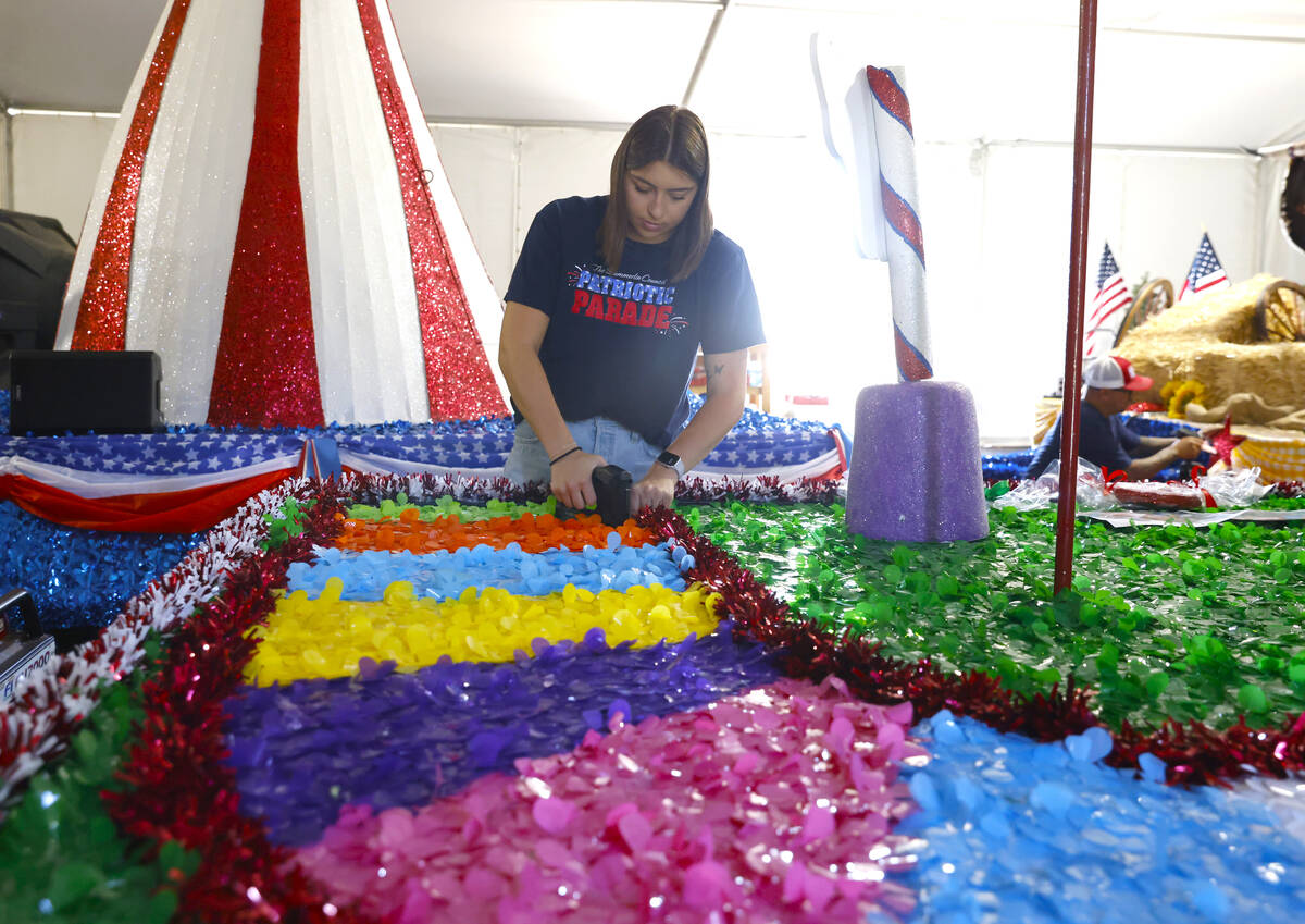 Jordyn Doyle, a volunteer, decorates the “Visions of Candy Land” float, to be featured in t ...