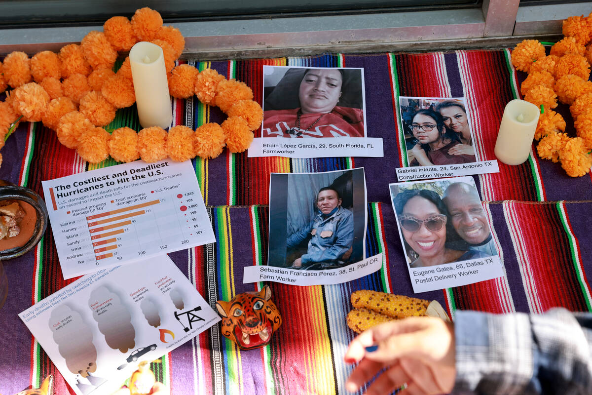 Photos that organizers said are of people who died from heat are shown during a protest with ac ...