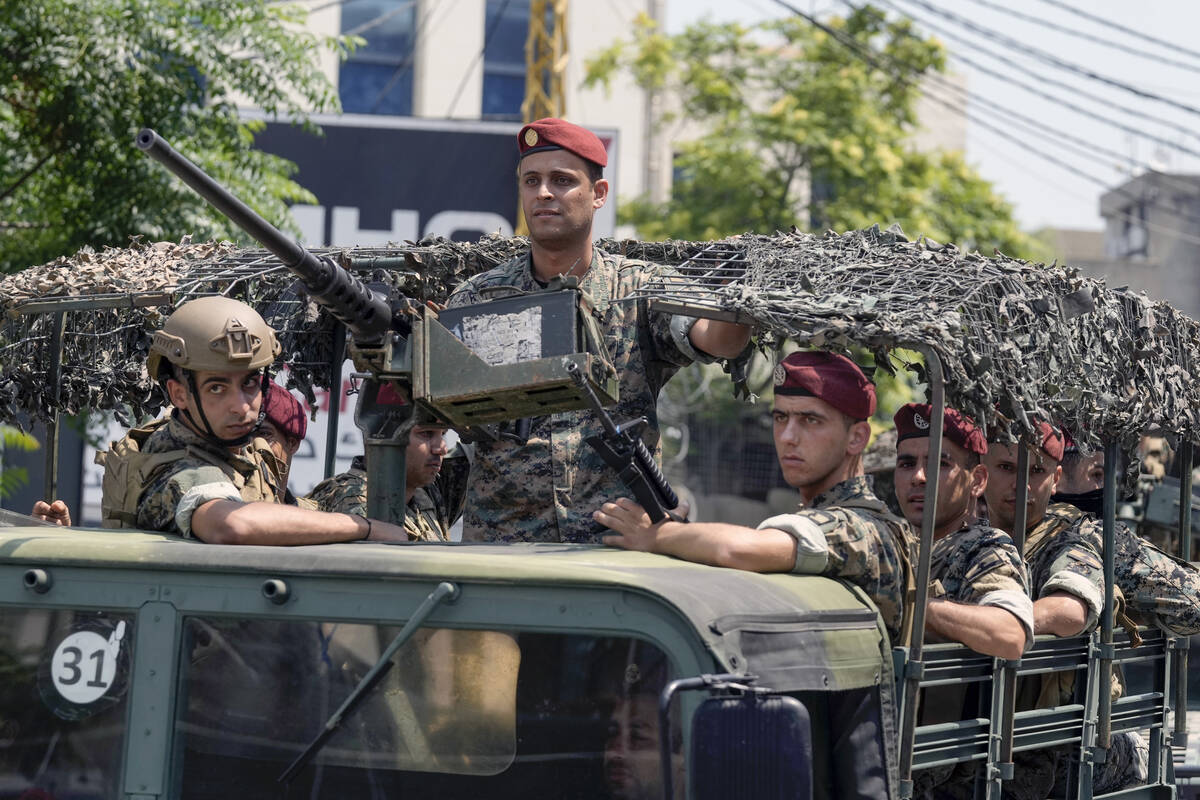 FILE - Lebanese special forces sit in their vehicle as they patrol on a road that leads to the ...