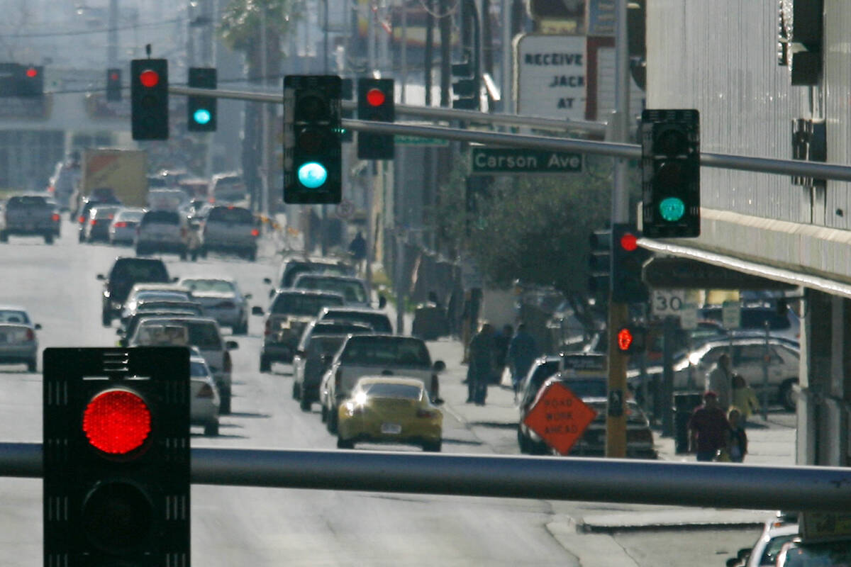 Red and green traffic lights are seen on Main Street in downtown Las Vegas. (Review-Journal file)
