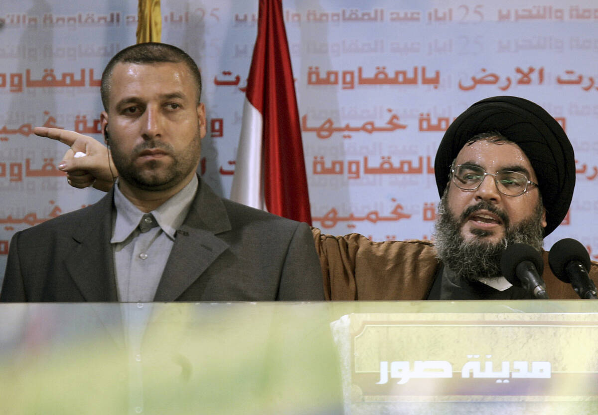 FILE - Hezbollah leader Sayyed Hassan Nasrallah, right, gives an address while accompanied by h ...