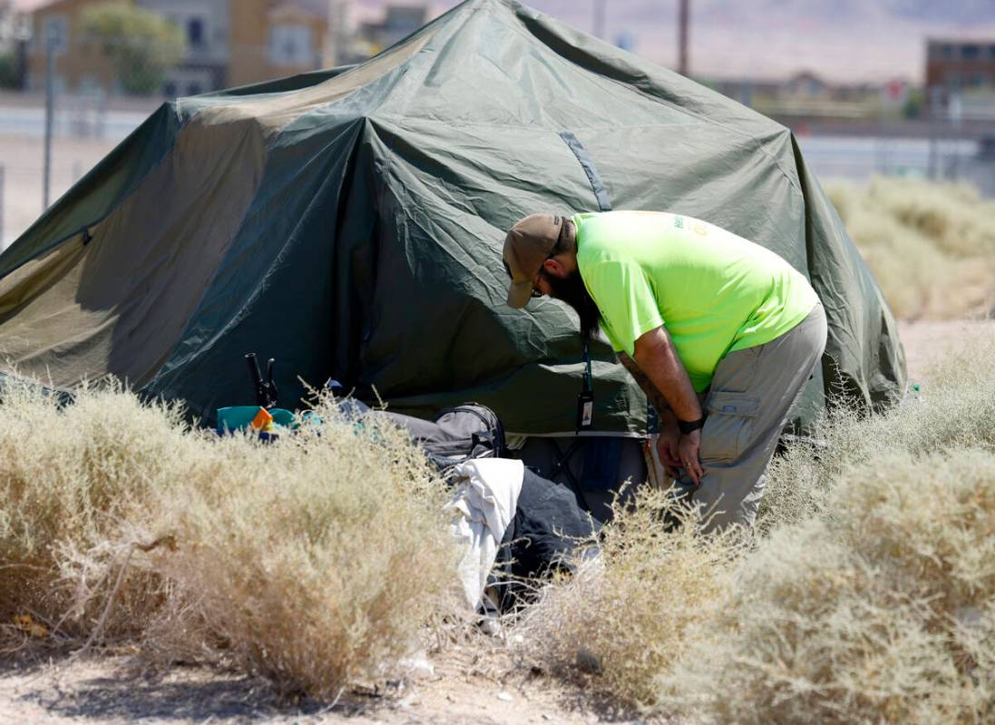 Richard Lopez, a Help of Southern Nevada Homeless Response Team lead, speaks to homeless people ...