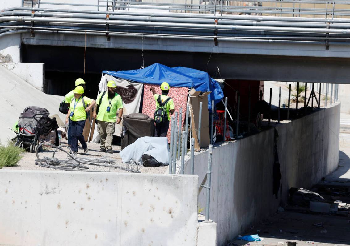 A Help of Southern Nevada outreach workers check out homeless encampment at Mountain Vista Stre ...
