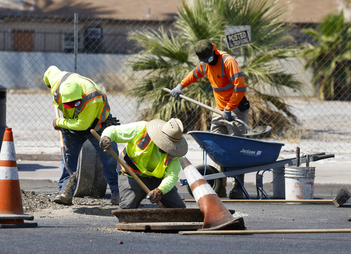 Jose Gonzales, left, Harold Arnold, center, and Manny Venegas, all from Las Vegas Paving, prepa ...