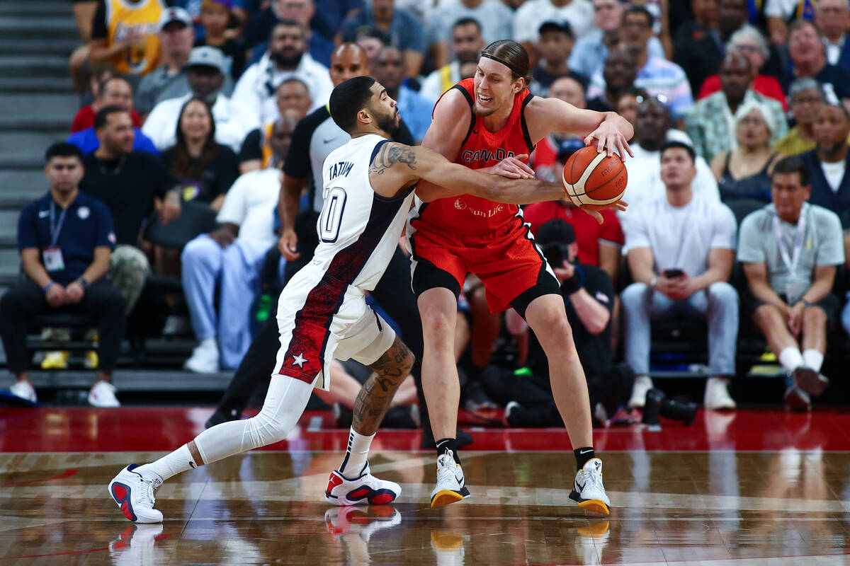 USA forward Jayson Tatum (10) defends against Canada center Kelly Olynyk (13) during the first ...