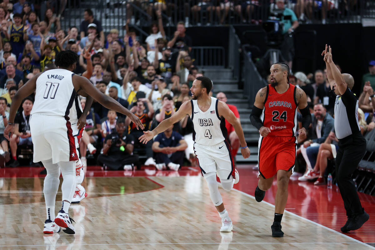 USA guard Stephen Curry (4) celebrates with USA center Joel Embiid (11) while Canada forward Di ...