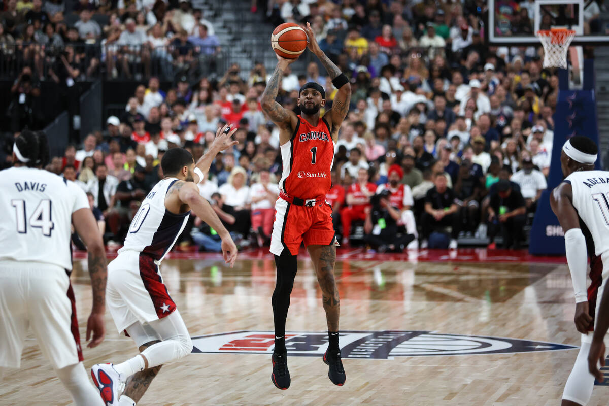 Canada guard Nickeil Alexander-Walker (1) shoots while USA forward Jayson Tatum (10) moves to b ...