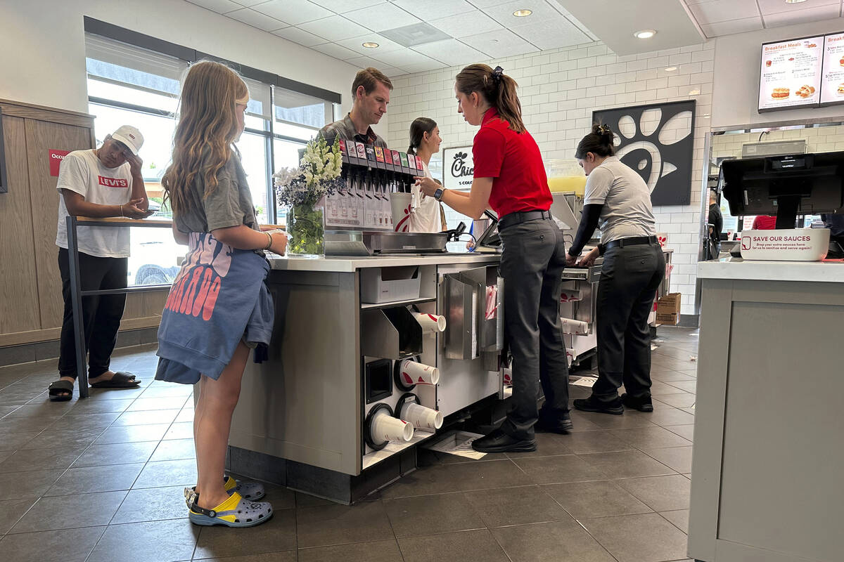 Workers serve customers at a fast food restaurant Thursday, June 27, 2024, in southeast Denver. ...