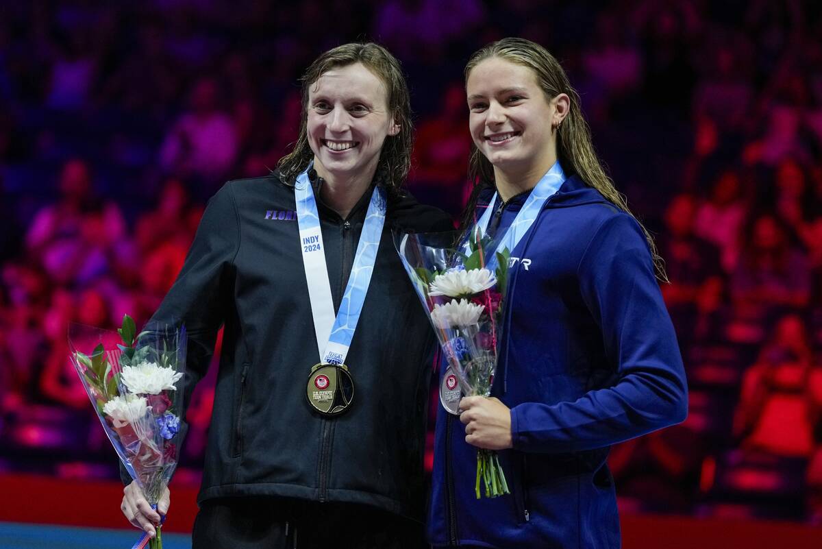 Katie Ledecky, left, and Katie Grimes celebrate after the Women's 1500 freestyle finals Wednesd ...