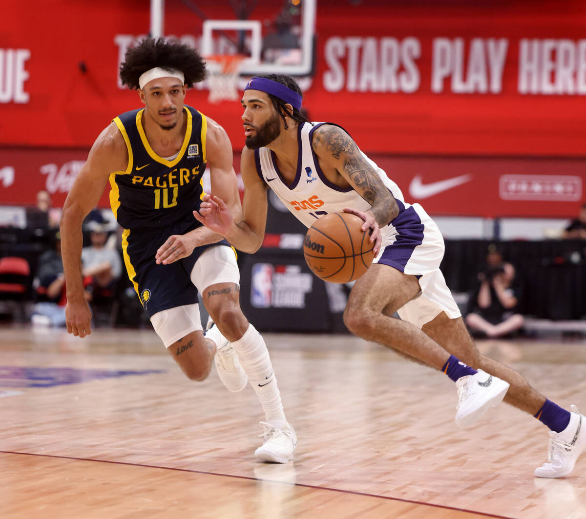 Phoenix Suns guard Boo Buie (17) drives past Indiana Pacers guard Kendall Brown (10) during an ...