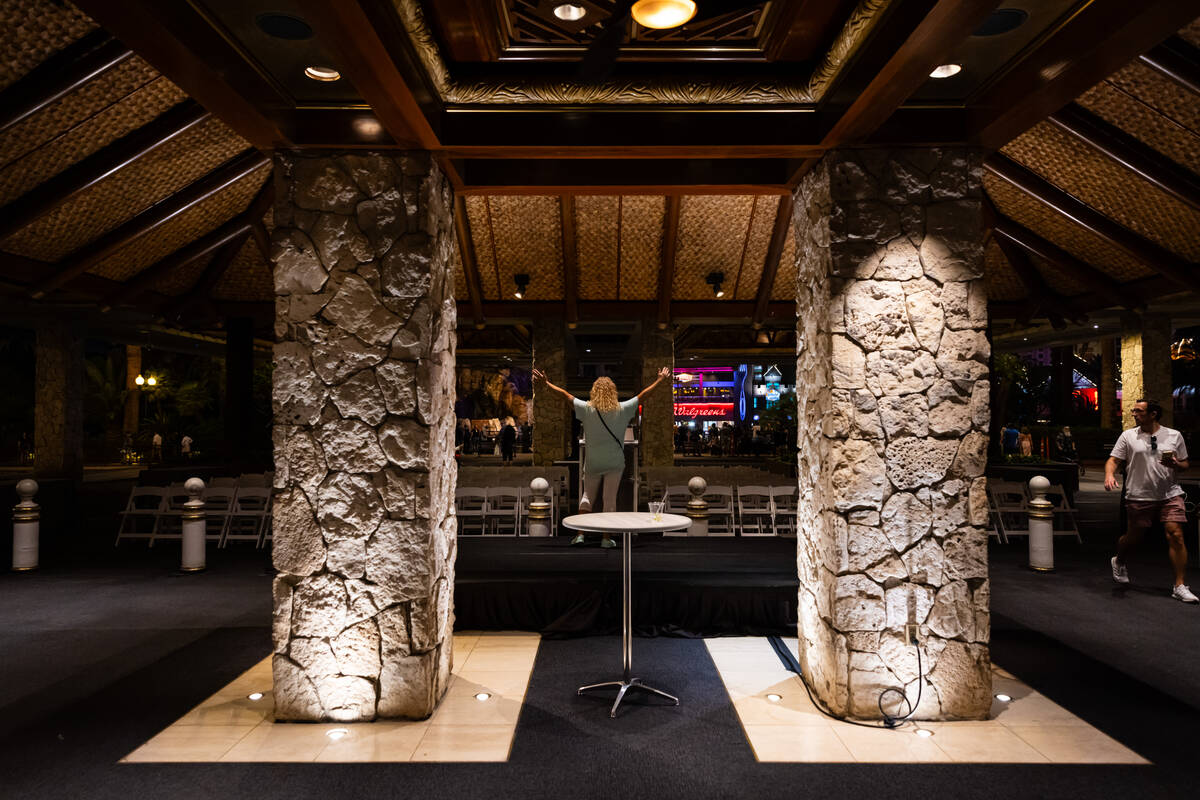 A woman poses by a podium, set up for a closing ceremony the next morning, during the final nig ...