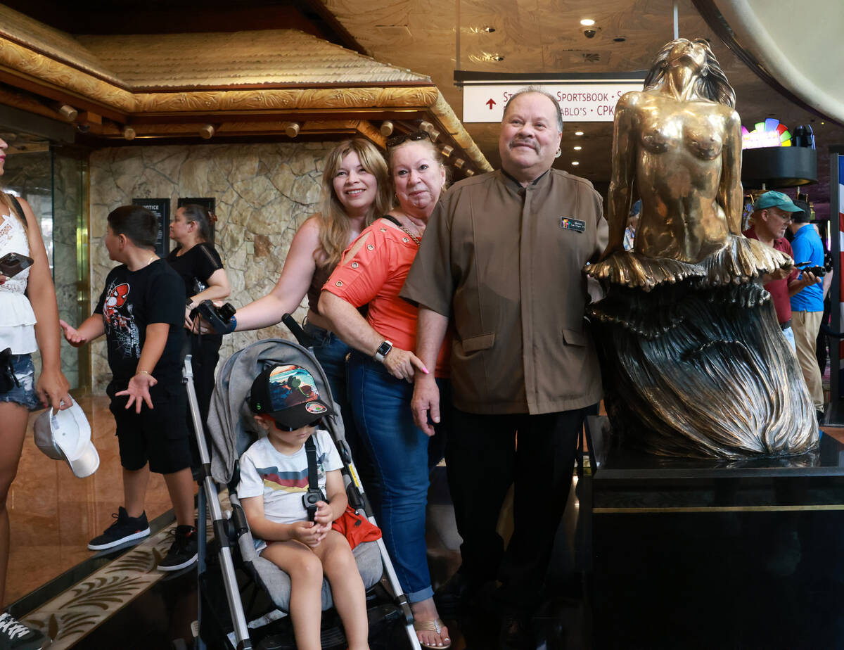 Thirty-three year employee Moises Ayala poses with his family on the final day of operations at ...