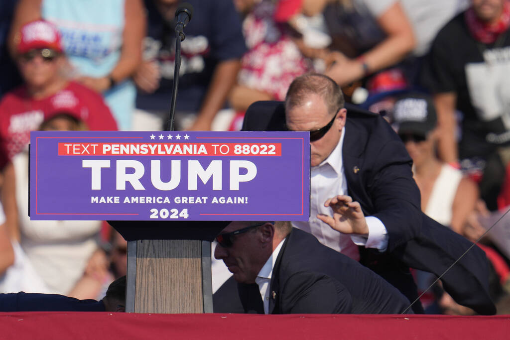 U.S. Secret Service agents surround Republican presidential candidate former President Donald T ...