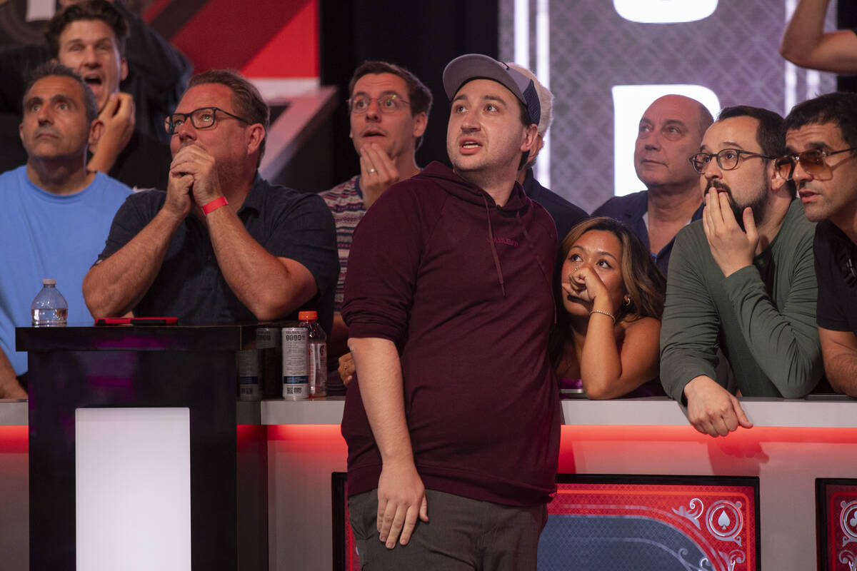 Jordan Griff, center, watches his hand play with family and friends in the final table of the W ...