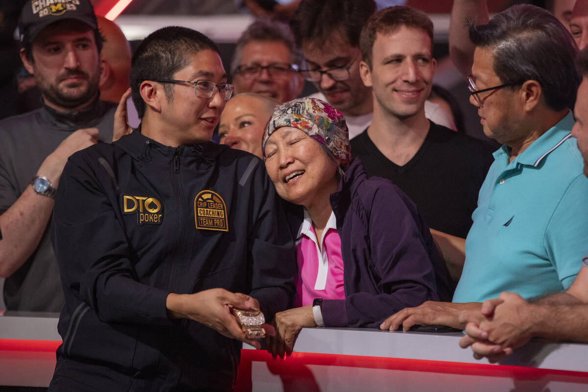 Jonathan Tamayo, left, celebrates with his family after winning the final table of the World Se ...