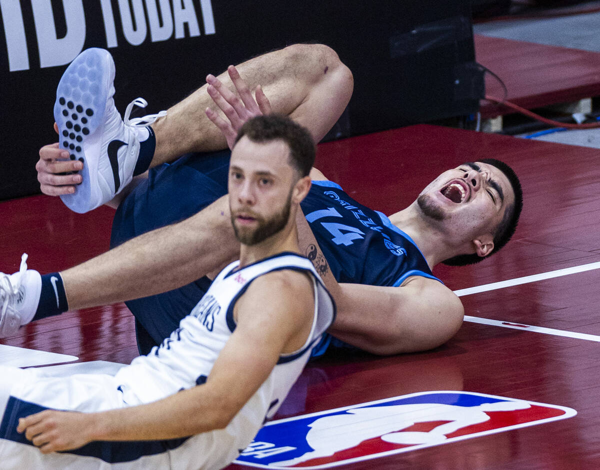 Memphis Grizzlies Center Zach Edey (14) grabs his lower leg after an injury against New Orleans ...