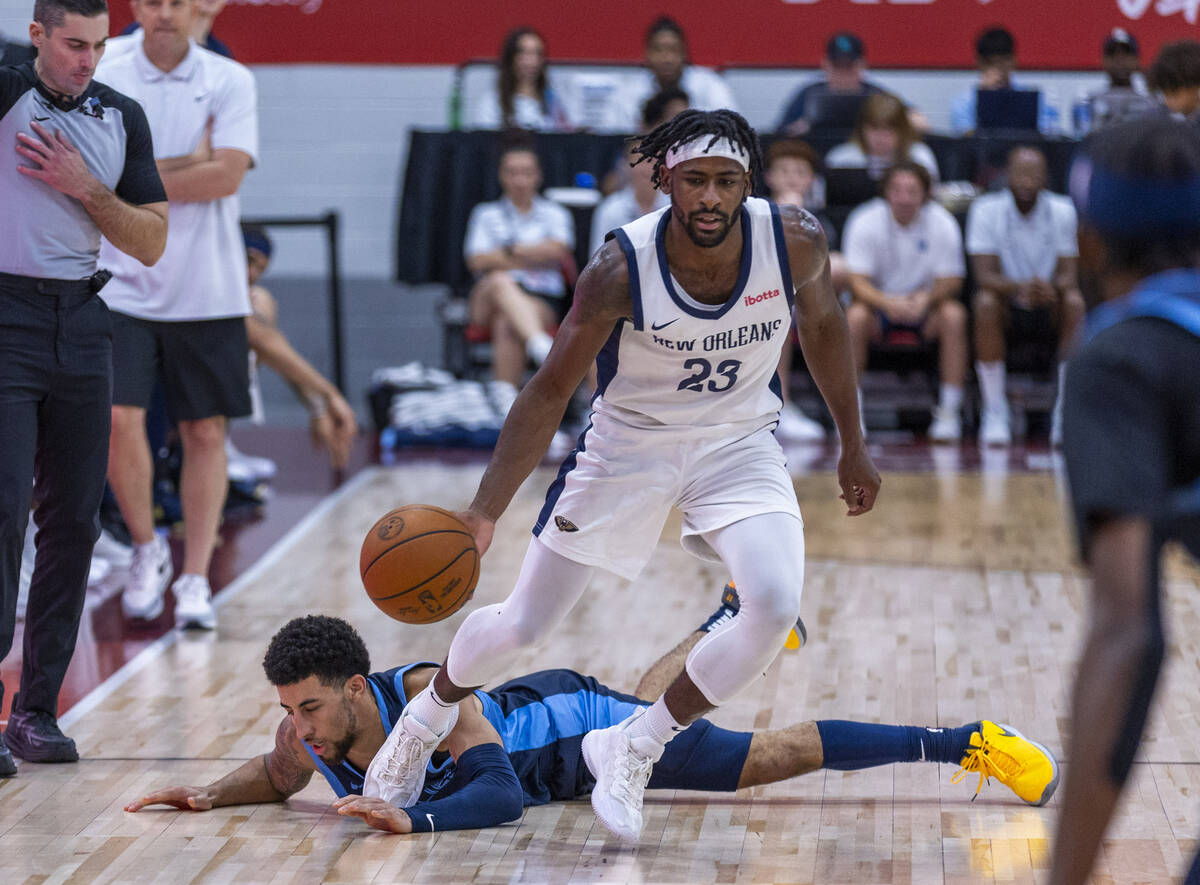 New Orleans Pelicans guard Izaiah Brockington (23) evades a steal attempt by Memphis Grizzlies ...