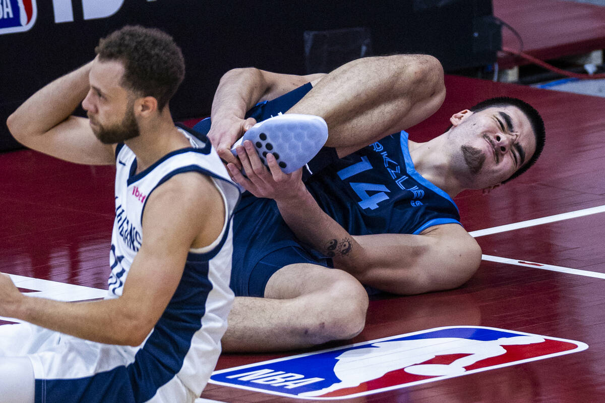 Memphis Grizzlies Center Zach Edey (14) grabs his lower leg after an injury against New Orleans ...