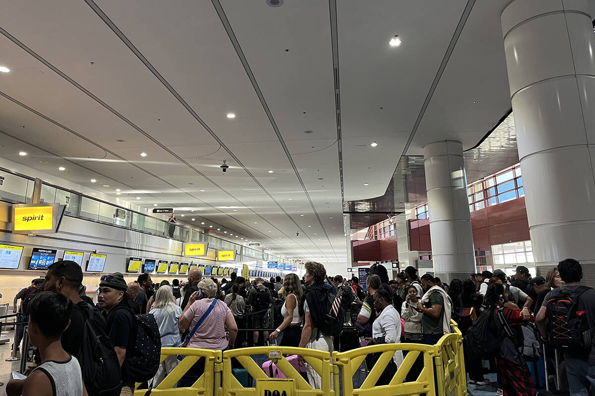 Travelers deal with a global technology outage Friday, July 19. 2024, at Harry Reid Internation ...