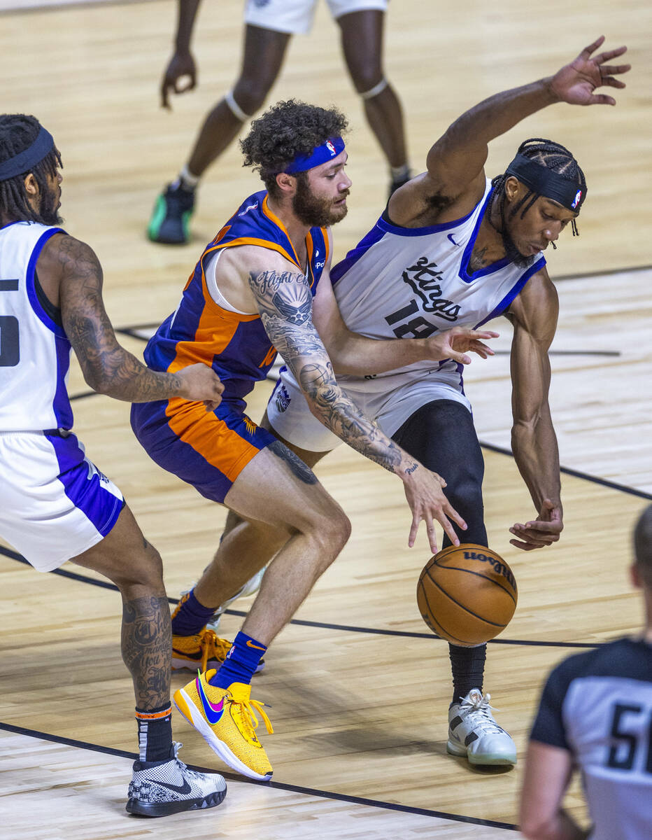 Phoenix Suns guard Logan Johnson (16) collides with Sacramento Kings forward Xavier Sneed (18) ...