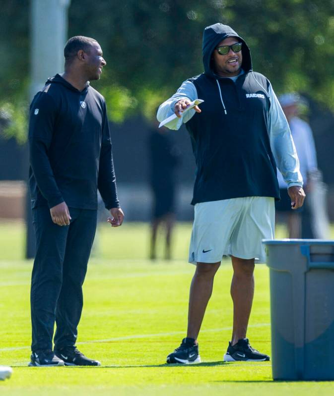Raiders head coach Antonio Pierce talks with a member of the staff during the second day of Rai ...