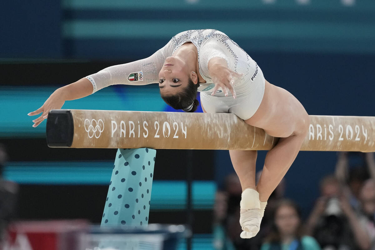 Manila Esposito, of Italy, performs on the balance beam during the women's artistic gymnastics ...