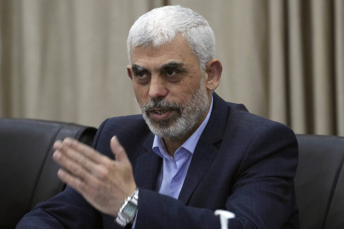 FILE - Yahya Sinwar, head of Hamas in Gaza, greets his supporters during a meeting with leaders ...