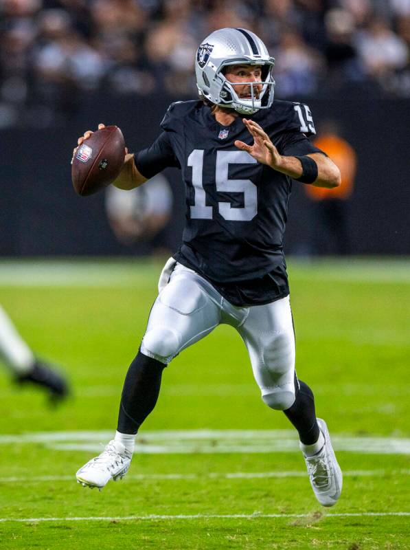 Raiders quarterback Gardner Minshew (15) looks for a receiver on the run against the Dallas Cow ...