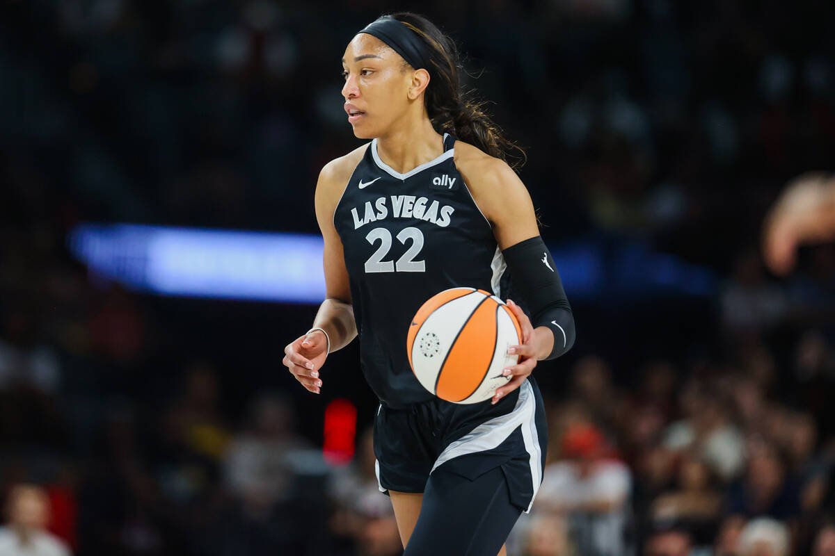 Aces center A'ja Wilson (22) dribbles the ball during a WNBA basketball game between the Aces a ...