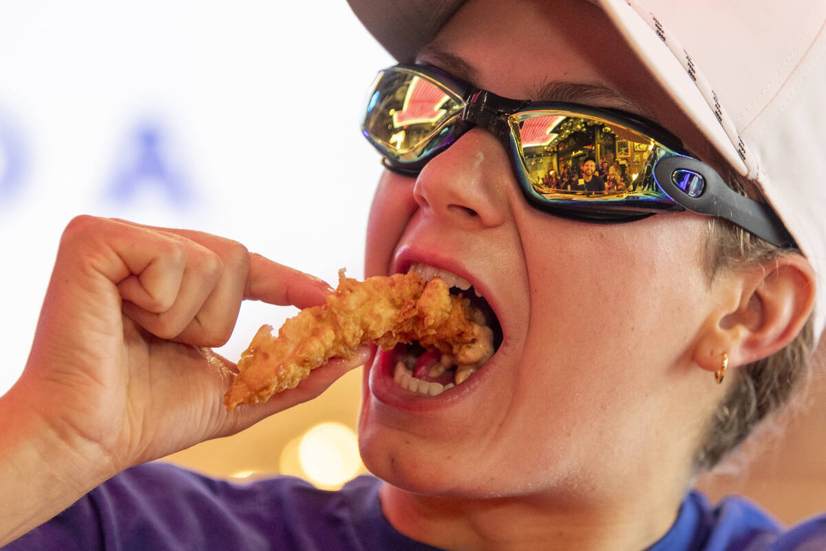 Olympic medalist Katie Grimes eats a chicken finger during a promotional homecoming “shi ...