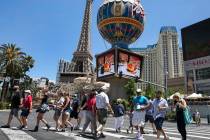Tourists cross Las Vegas Boulevard near Paris hotel-casino on Friday, July 3, 2020, in Las Veg ...