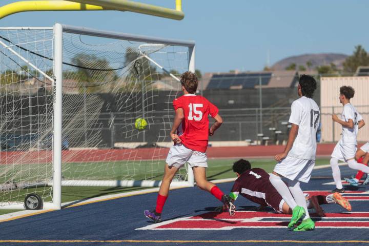 Coronado's Ben Aronow (15) kicks the ball past Cimarron-Memorial goalkeeper Dylan Crosby-Moghad ...
