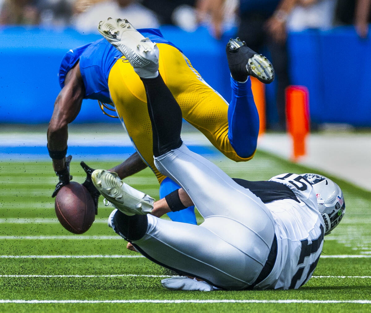 Los Angeles Chargers cornerback Kristian Fulton (7) works to scoop up a lateral that got away f ...