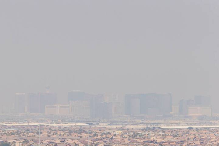 Strong winds blow in smoke from wildfires across the west coast, shrouding the city in a haze, ...