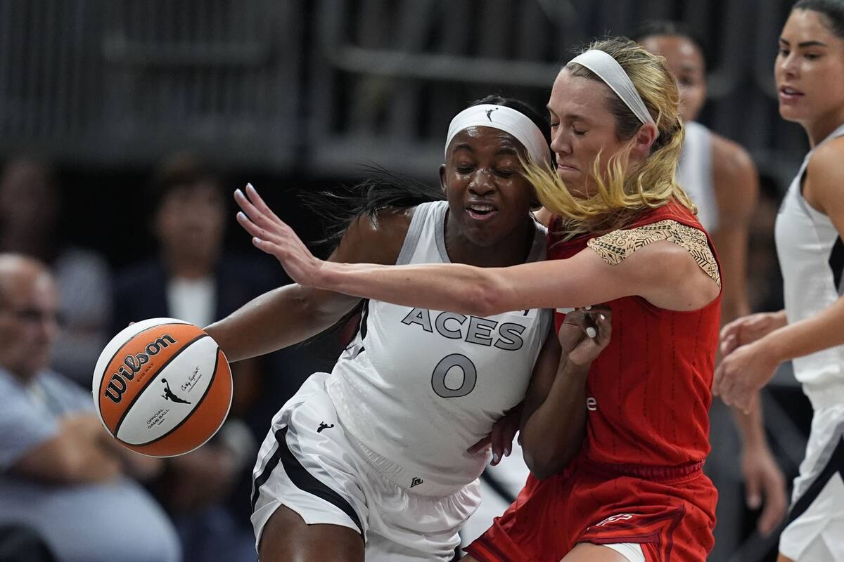 Las Vegas Aces' Jackie Young (0) is defended by Indiana Fever's Lexie Hull during the first hal ...