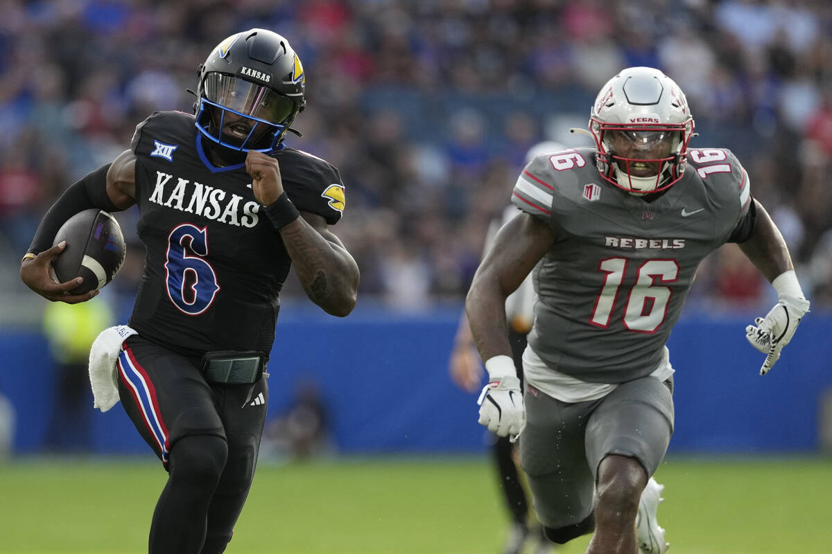 Kansas quarterback Jalon Daniels (6) runs for a touchdown against UNLV linebacker Mani Powell ( ...