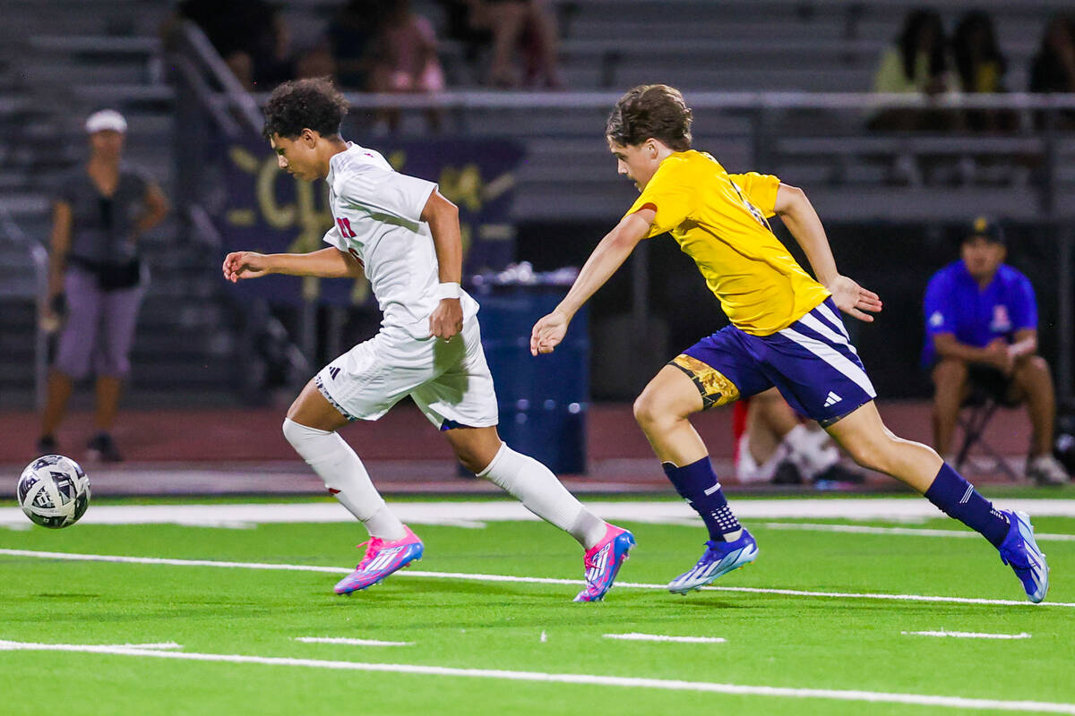 Liberty soccer forward Justin Gilliland, left, chases the ball as Shadow Ridge midfielder Conno ...