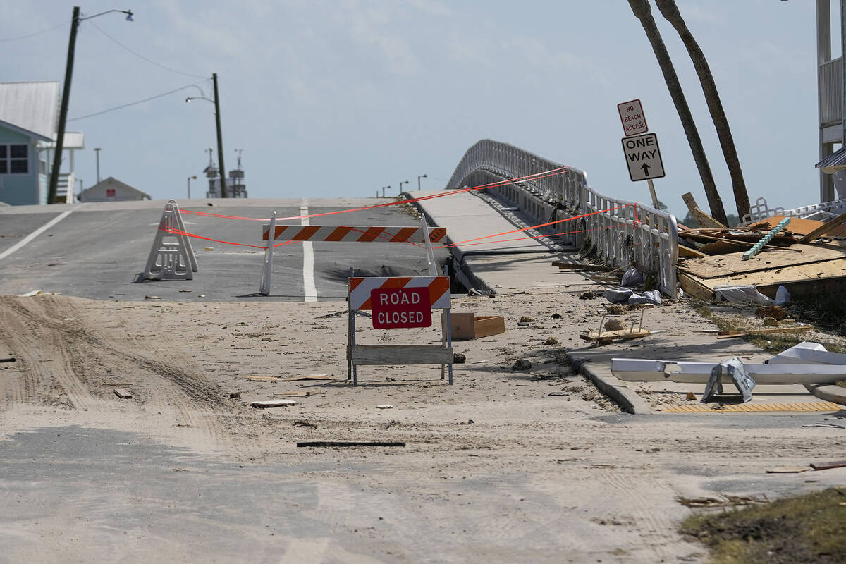 A damaged bridge is barricaded off in the aftermath of Hurricane Helene, in Cedar Key, Fla., Fr ...