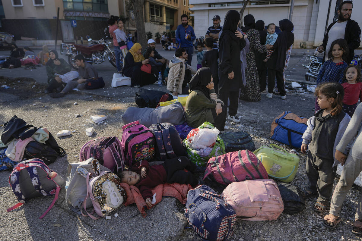 Families gather in Martyrs' square after fleeing the Israeli airstrikes in Beirut's southern su ...