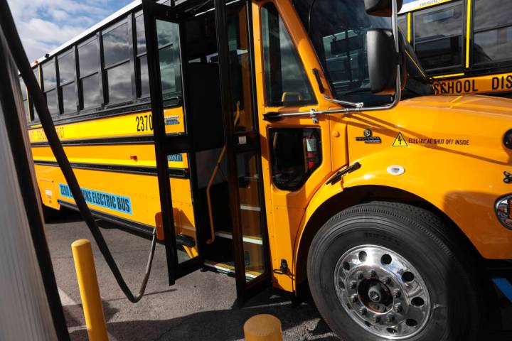 FILE - An electric school bus acquired by the Clark County School District charges at the Arvil ...