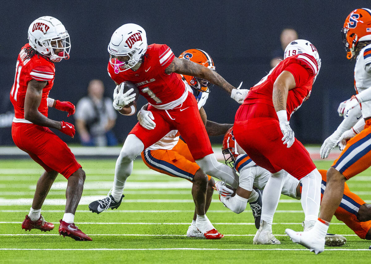 UNLV wide receiver Casey Cain (1) breaks a Syracuse Orange tackle attempt during the first half ...