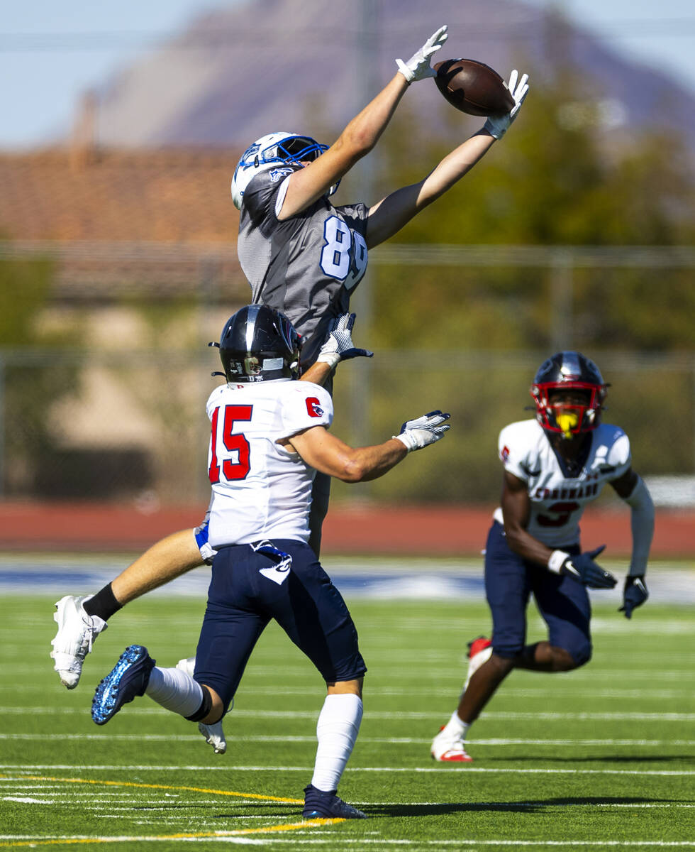 Basic wide receiver Hunter McGory (89) elevates for a reception attempt as Coronado linebacker ...