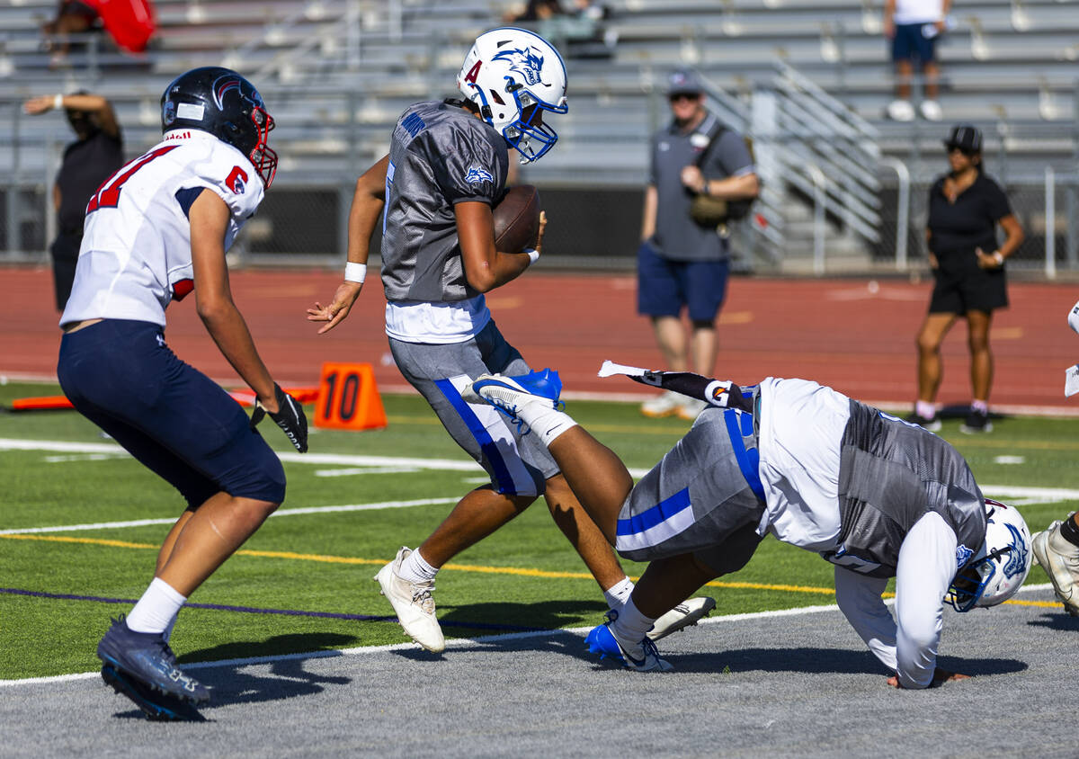 Basic quarterback Parker Simmons (5) scampers into the end zone as Coronado defensive back Nick ...