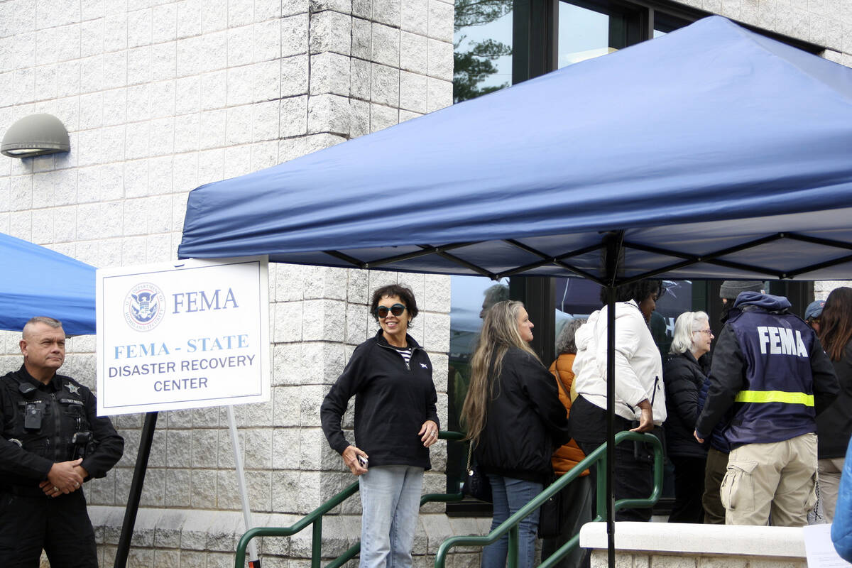 People gather at a FEMA Disaster Recovery Center at A.C. Reynolds High School in Asheville, N.C ...