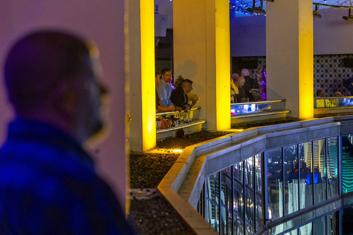 Guests look out from the balcony before the Tropicana is imploded early in the morning while vi ...