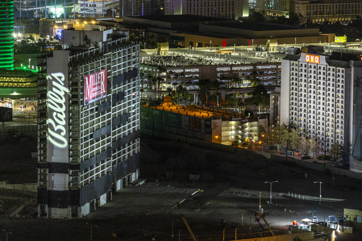 People gather on the MGM Grand garage to view the Tropicana being imploded early in the morning ...