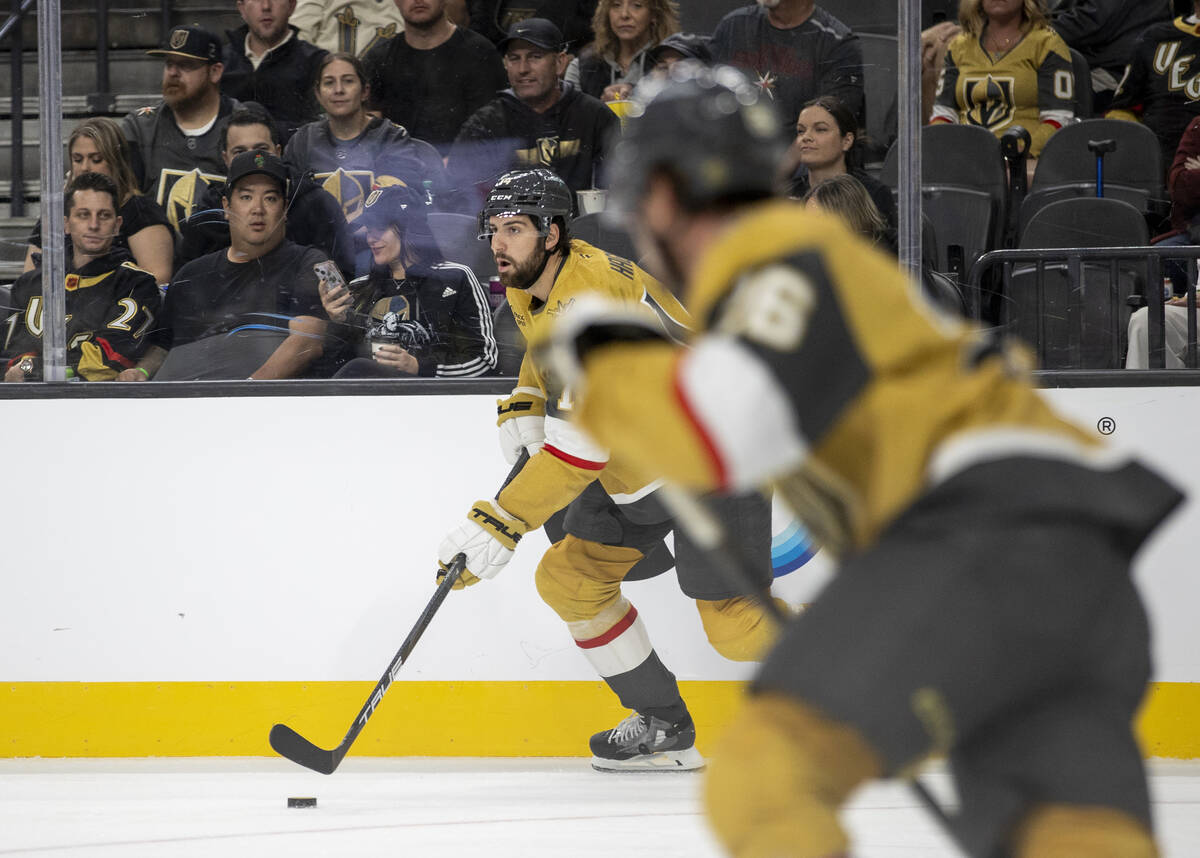 Golden Knights defenseman Nicolas Hague (14) skates with the puck during the NHL hockey game ag ...